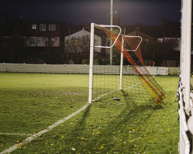 A photo of a football goal, with the pitch looking empty.