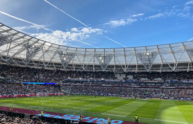 A photo of two teams walking out at the London Stadium with bubbles in the foreground.