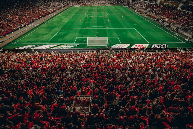 A photo of football fans inside a stadium.